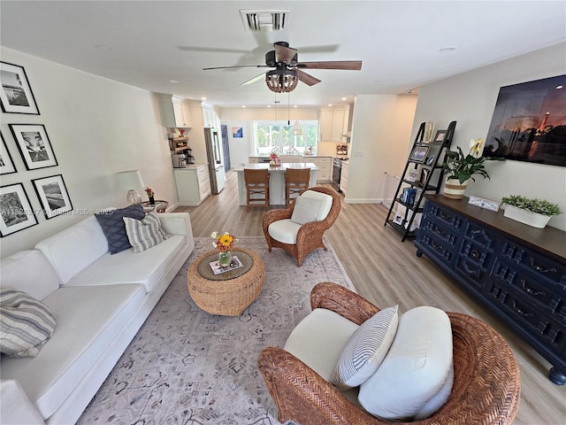 8994 SE Colony St, Hobe Sound, FL 33455 - living area with light wood-type flooring, a ceiling fan, and recessed lighting