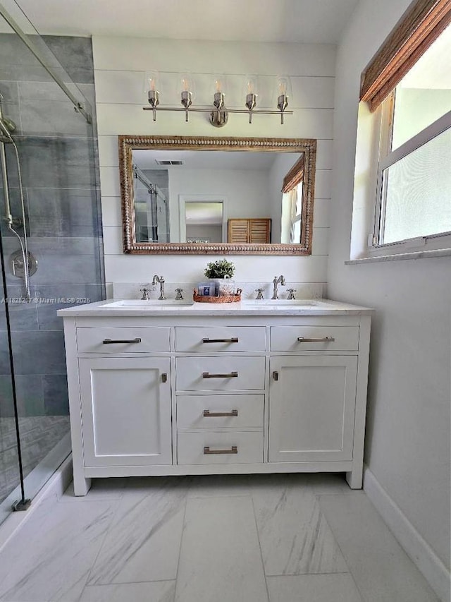 8994 SE Colony St, Hobe Sound, FL 33455 - full bath featuring marble look tile flooring, a stall shower, and double vanity