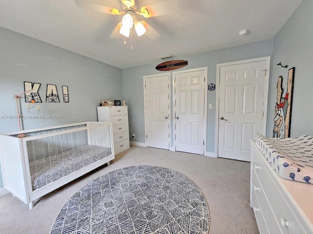 8994 SE Colony St, Hobe Sound, FL 33455 - bedroom with light colored carpet, a ceiling fan, and a closet