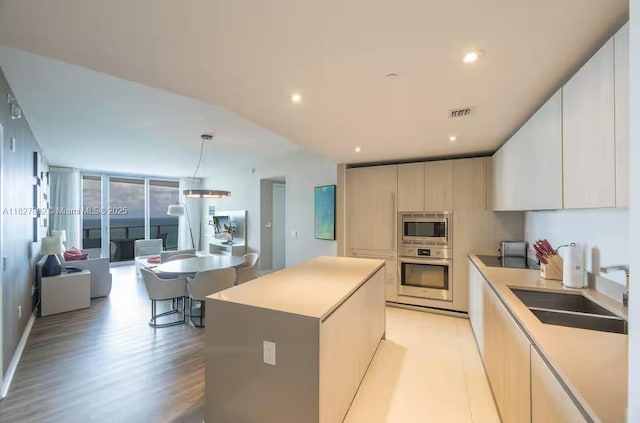 4111 S Ocean Dr Unit 2204, Hollywood, FL 33019 - kitchen with stainless steel appliances, modern cabinets, a kitchen island, light countertops, and light wood-style floors