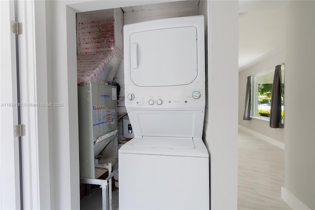 246 NE 13th St, Delray Beach, FL 33444 - laundry area with stacked washing machine and dryer and wood finished floors