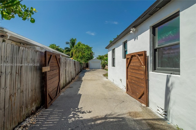 246 NE 13th St, Delray Beach, FL 33444 - view of property exterior with stucco siding and an outdoor structure