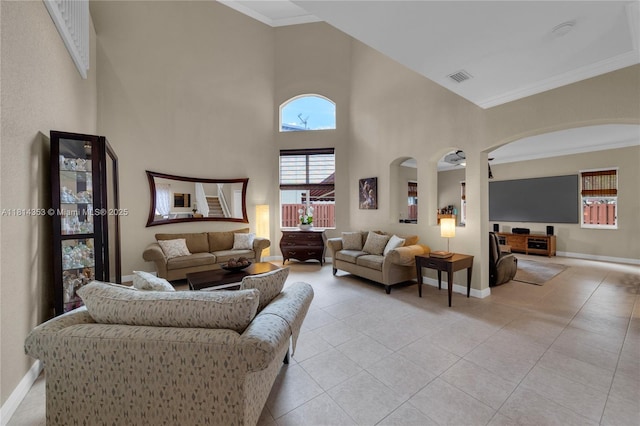 14141 SW 54th St, Miramar, FL 33027 - living room featuring arched walkways, a high ceiling, ornamental molding, and light tile patterned floors