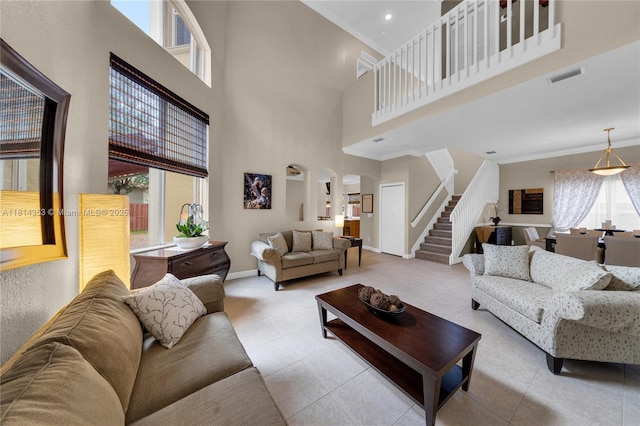 14141 SW 54th St, Miramar, FL 33027 - tiled living area with arched walkways, stairs, a high ceiling, crown molding, and recessed lighting
