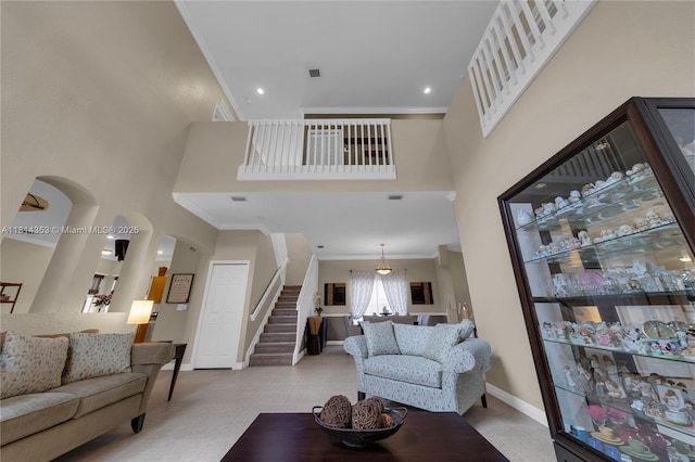 14141 SW 54th St, Miramar, FL 33027 - living room featuring ornamental molding, stairs, and a high ceiling
