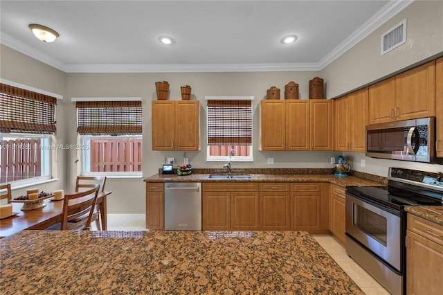 14141 SW 54th St, Miramar, FL 33027 - kitchen with stainless steel appliances, crown molding, recessed lighting, dark stone counters, and light tile patterned floors