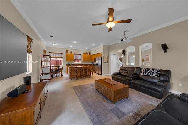 14141 SW 54th St, Miramar, FL 33027 - living room featuring a ceiling fan, arched walkways, crown molding, light tile patterned flooring, and recessed lighting