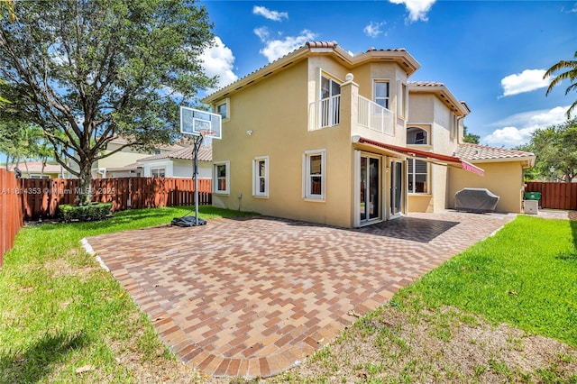14141 SW 54th St, Miramar, FL 33027 - rear view of property with a balcony, stucco siding, a fenced backyard, a tile roof, and a patio