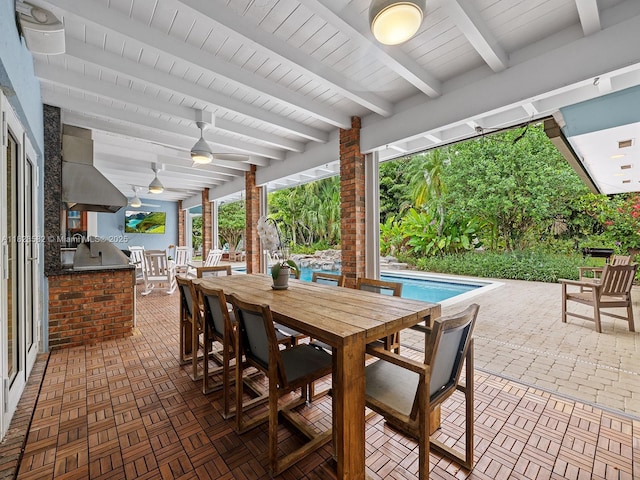 6005 SW 135th Ter, Pinecrest, FL 33156 - view of patio with an outdoor kitchen, outdoor dining area, ceiling fan, and an outdoor pool