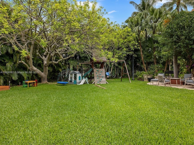 6005 SW 135th Ter, Pinecrest, FL 33156 - view of green lawn with a playground and a patio