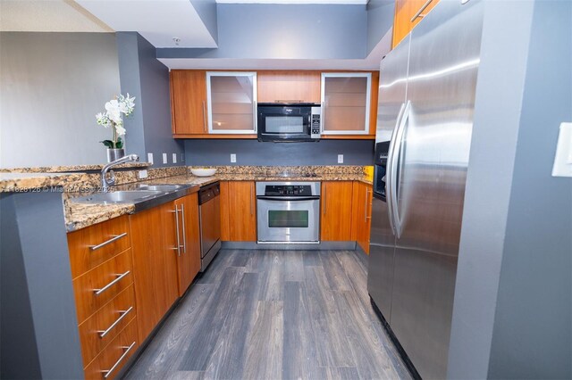 888 S Douglas Rd Unit Ph07, Coral Gables, FL 33134 - kitchen with black appliances, dark wood-type flooring, brown cabinetry, and light stone countertops