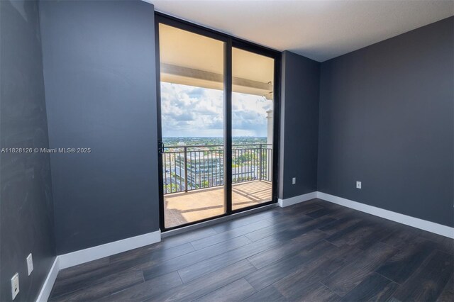 888 S Douglas Rd Unit Ph07, Coral Gables, FL 33134 - empty room with dark wood finished floors and expansive windows