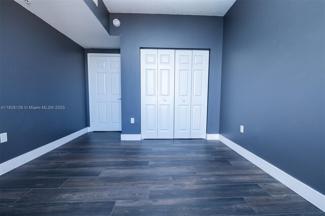 888 S Douglas Rd Unit Ph07, Coral Gables, FL 33134 - unfurnished bedroom featuring a closet and wood finished floors