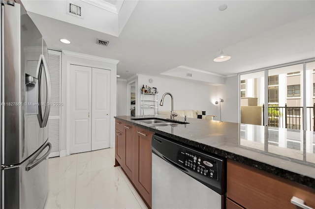 4100 Salzedo St Unit 515, Coral Gables, FL 33146 - kitchen featuring appliances with stainless steel finishes, brown cabinets, light marble finish floors, dark stone countertops, and crown molding