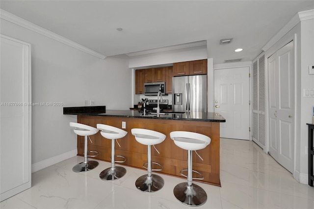 4100 Salzedo St Unit 515, Coral Gables, FL 33146 - kitchen featuring stainless steel appliances, a peninsula, light marble finish flooring, crown molding, and a kitchen bar