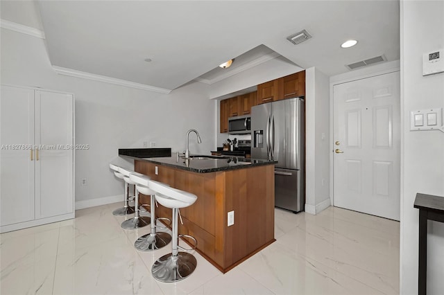 4100 Salzedo St Unit 515, Coral Gables, FL 33146 - kitchen featuring stainless steel appliances, crown molding, light marble finish flooring, a breakfast bar, and a peninsula