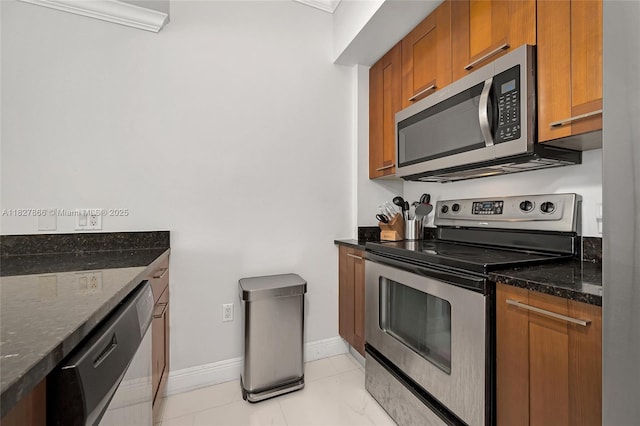 4100 Salzedo St Unit 515, Coral Gables, FL 33146 - kitchen with appliances with stainless steel finishes, brown cabinets, and dark stone counters
