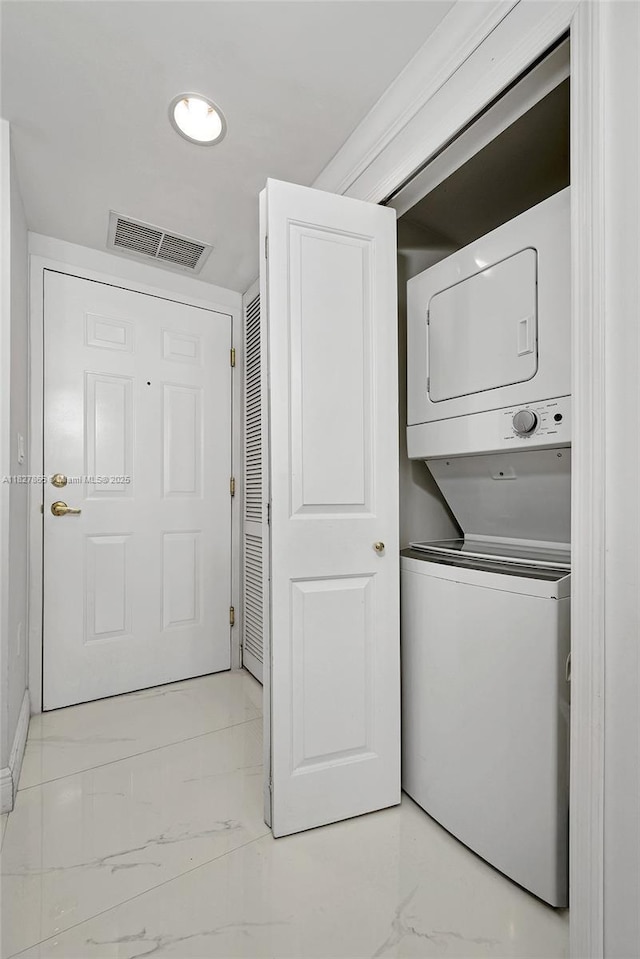 4100 Salzedo St Unit 515, Coral Gables, FL 33146 - laundry area featuring stacked washer and clothes dryer and marble look tile flooring