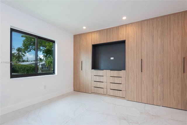 2181 SW 20th St, Miami, FL 33145 - unfurnished bedroom with light marble finish flooring and recessed lighting