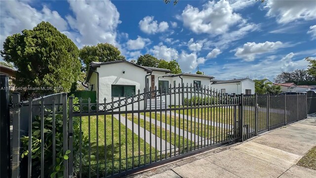 2181 SW 20th St, Miami, FL 33145 - view of front of home with stucco siding, a gate, and a fenced front yard