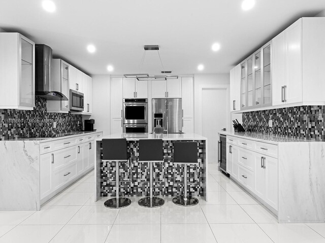 4501 SW 133rd Ave, Southwest Ranches, FL 33330 - kitchen featuring stainless steel appliances, wall chimney exhaust hood, tasteful backsplash, recessed lighting, and beverage cooler