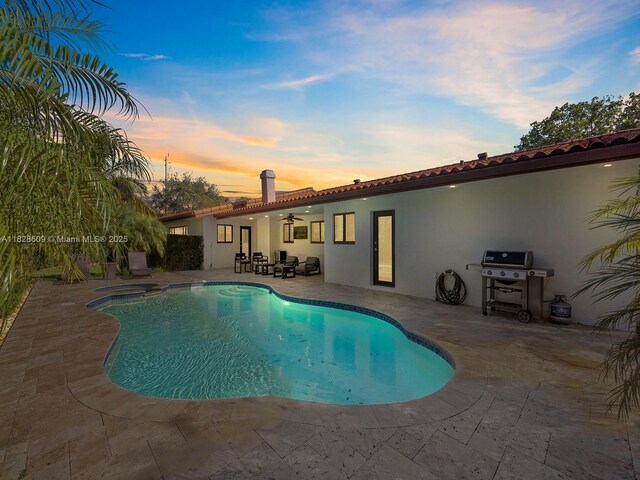 4501 SW 133rd Ave, Southwest Ranches, FL 33330 - pool at dusk with a patio, ceiling fan, a grill, and a pool with connected hot tub