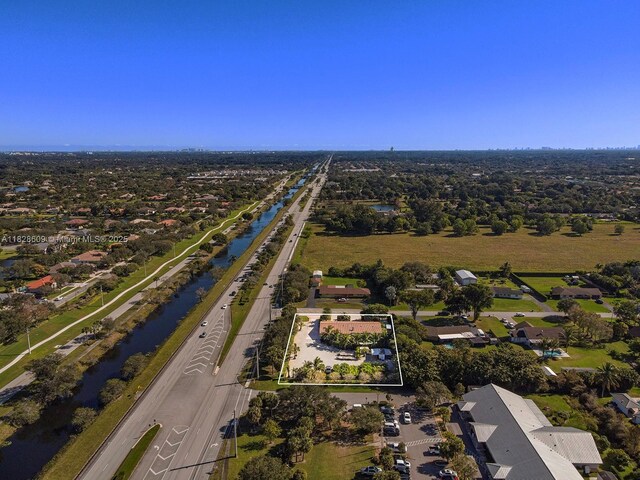 4501 SW 133rd Ave, Southwest Ranches, FL 33330 - aerial view of property's location with property boundaries highlighted, a nearby body of water, and nearby suburban area