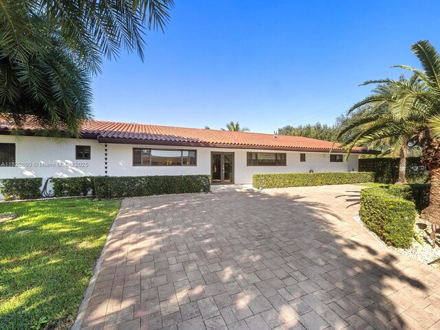 4501 SW 133rd Ave, Southwest Ranches, FL 33330 - mediterranean / spanish house featuring stucco siding, french doors, a tile roof, and a front yard