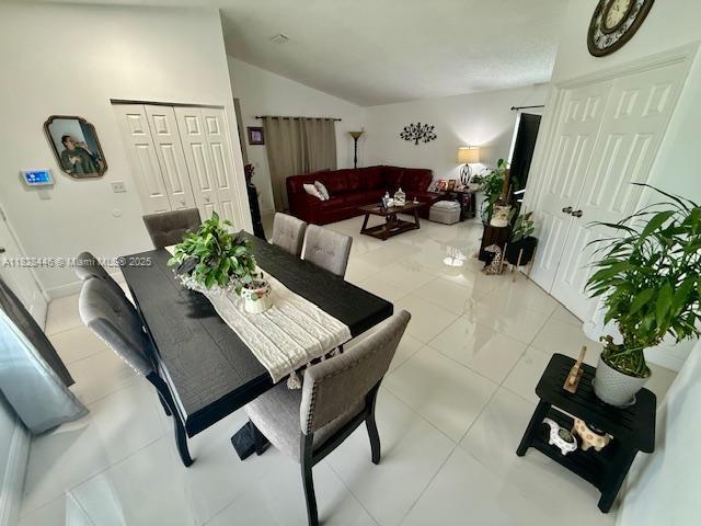 767 SE 22nd Dr, Homestead, FL 33033 - dining room with lofted ceiling and light tile patterned flooring