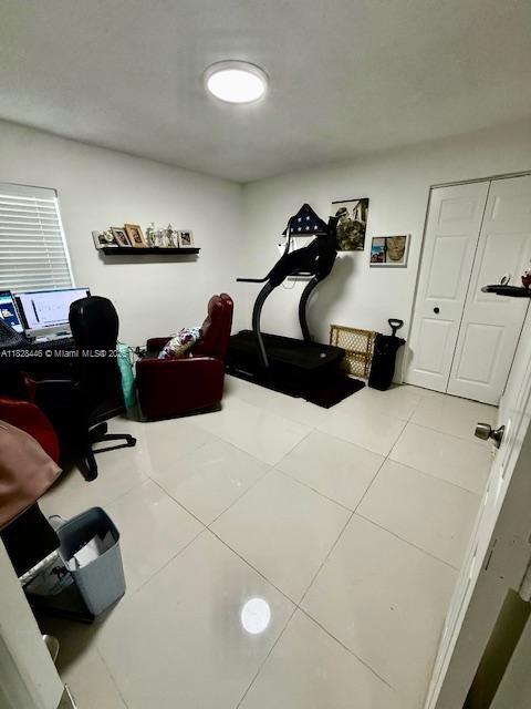 767 SE 22nd Dr, Homestead, FL 33033 - exercise area with tile patterned flooring