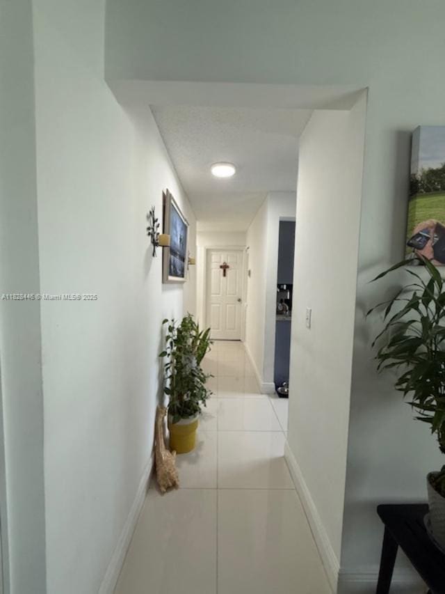 767 SE 22nd Dr, Homestead, FL 33033 - hall featuring baseboards and light tile patterned floors