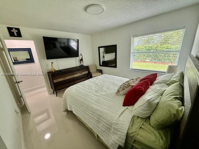767 SE 22nd Dr, Homestead, FL 33033 - bedroom with a textured ceiling