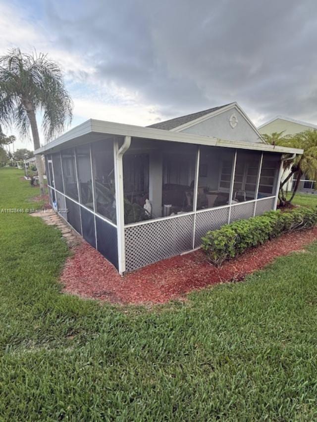 767 SE 22nd Dr, Homestead, FL 33033 - view of side of home featuring a sunroom and a yard