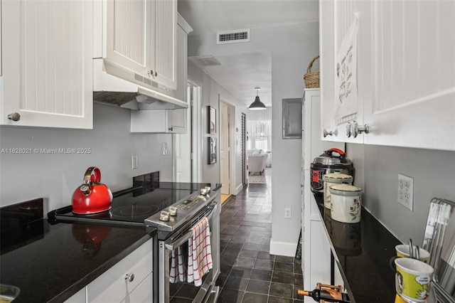 405 SW 29th Ct Unit 4A, Miami, FL 33135 - kitchen featuring stainless steel range with electric stovetop, under cabinet range hood, white cabinets, and dark countertops