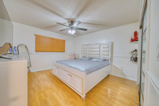 10000 SW 147th Ct, Miami, FL 33196 - bedroom with light wood-style flooring, a textured ceiling, and a ceiling fan