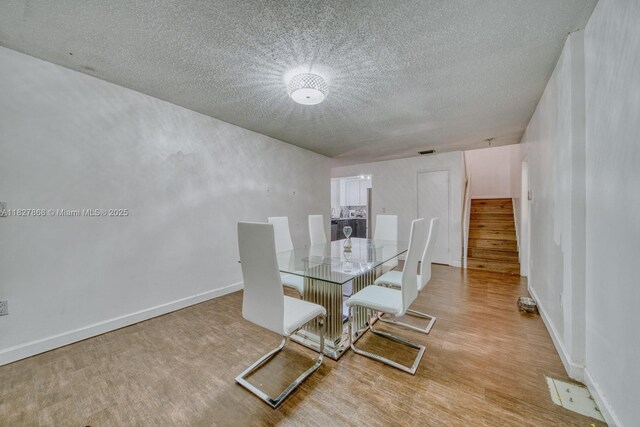 10000 SW 147th Ct, Miami, FL 33196 - dining space with a textured ceiling, stairway, and wood finished floors