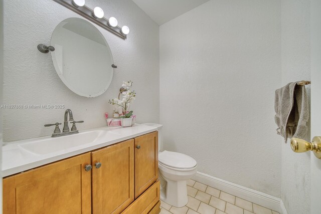 10000 SW 147th Ct, Miami, FL 33196 - bathroom with vanity, tile patterned floors, and a textured wall