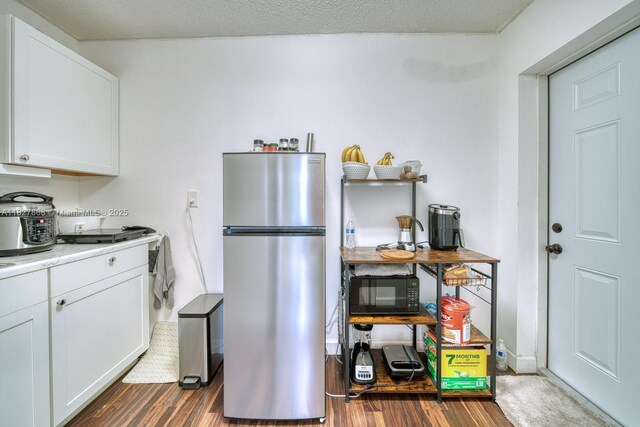 10000 SW 147th Ct, Miami, FL 33196 - kitchen featuring freestanding refrigerator, black microwave, dark wood finished floors, white cabinetry, and light countertops