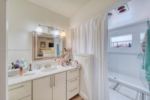 10000 SW 147th Ct, Miami, FL 33196 - full bathroom with vanity, a stall shower, ensuite bathroom, and a textured ceiling