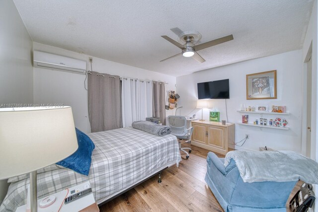 10000 SW 147th Ct, Miami, FL 33196 - bedroom with a wall mounted AC, wood finished floors, a textured ceiling, and ceiling fan