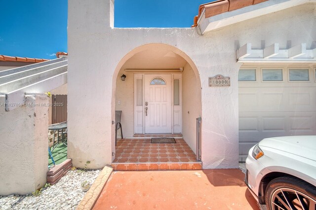 10000 SW 147th Ct, Miami, FL 33196 - doorway to property with stucco siding and a garage