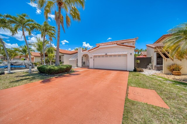 10000 SW 147th Ct, Miami, FL 33196 - mediterranean / spanish-style house with an attached garage, stucco siding, concrete driveway, and a tile roof