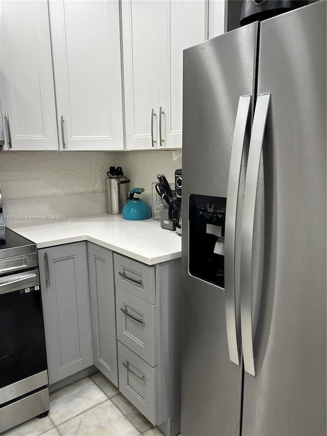 38 Northampton B 38, West Palm Beach, FL 33417 - kitchen featuring appliances with stainless steel finishes, gray cabinetry, light countertops, and white cabinets