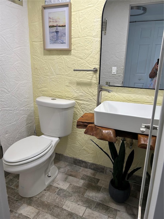 38 Northampton B 38, West Palm Beach, FL 33417 - half bath featuring a textured wall and stone finish flooring