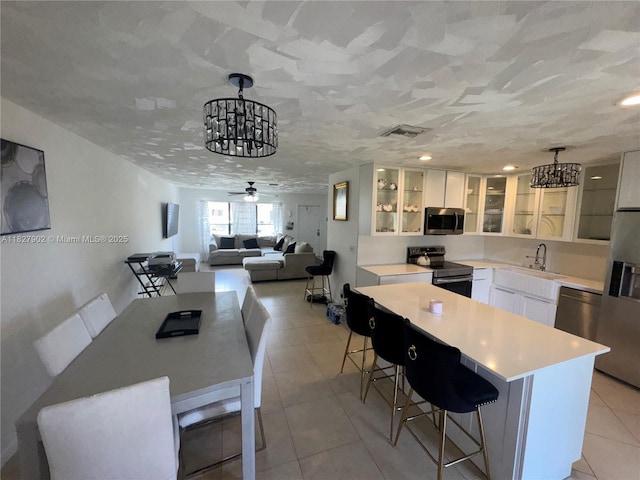 3370 Beau Rivage Dr, Pompano Beach, FL 33064 - dining area with a chandelier, light tile patterned flooring, and a ceiling fan