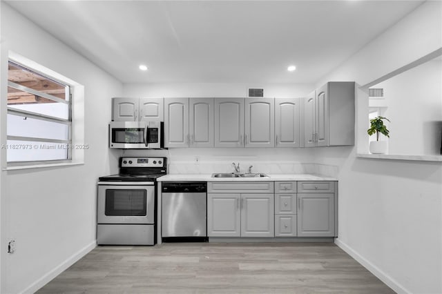 3494 SW 56th Ave, West Park, FL 33023 - kitchen with stainless steel appliances, gray cabinetry, light wood-type flooring, and recessed lighting