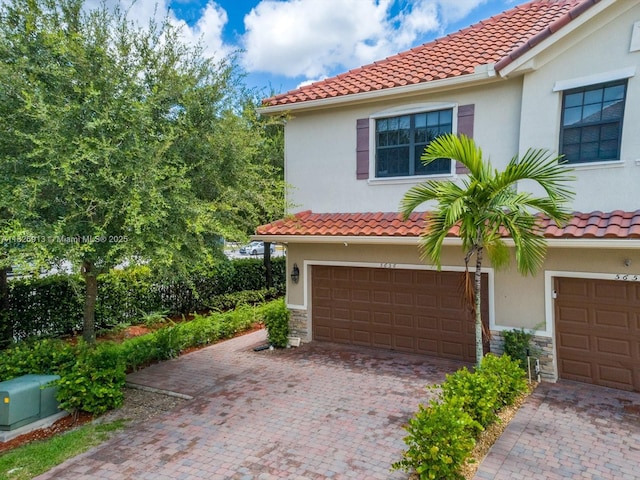 5656 NW 58th Ln, Tamarac, FL 33319 - view of front of house with a tile roof, stucco siding, and an attached garage