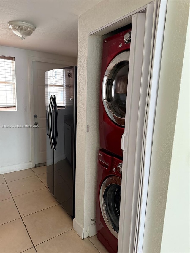 1142 99th St Unit 23, Bay Harbor Islands, FL 33154 - laundry room featuring estacked washer and dryer and light tile patterned flooring