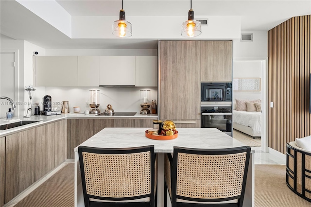 2900 NE 7th Ave Unit 2303, Miami, FL 33137 - kitchen featuring black appliances, modern cabinets, light countertops, and hanging light fixtures
