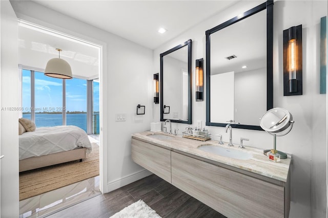 2900 NE 7th Ave Unit 2303, Miami, FL 33137 - ensuite bathroom with double vanity, a water view, wood finished floors, and recessed lighting